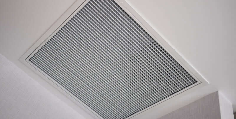 Vent for a reverse cycle ducted air conditioning system installed on the ceiling of a room. 
