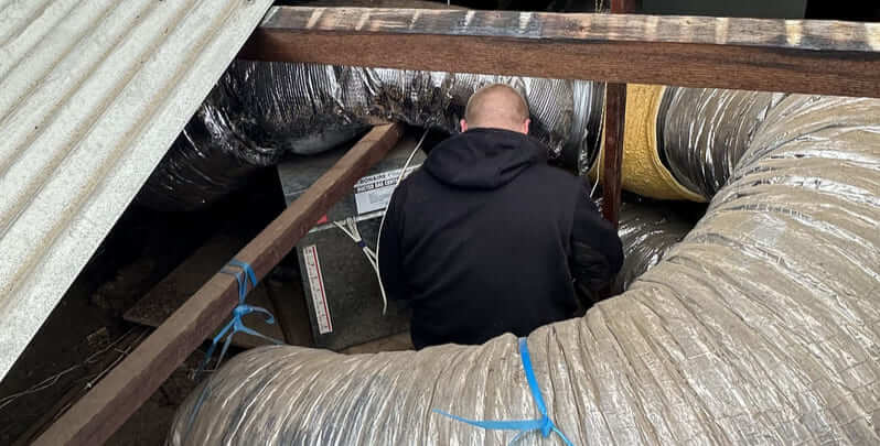 technician working on a ducted air conditioning unit