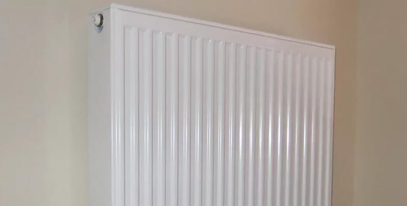 A wall mounted hydronic heating system radiator panel. 